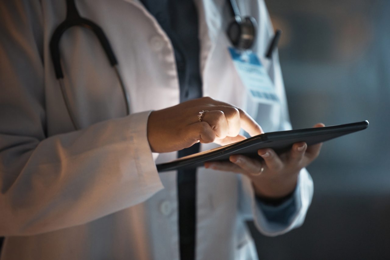 Doctor reviewing a tablet in a hospital office