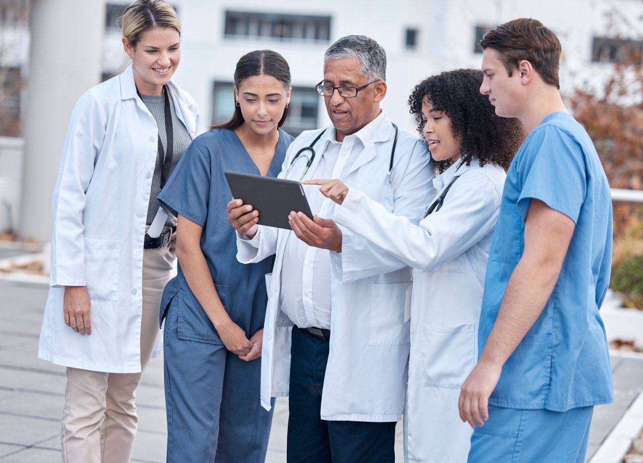 Doctors collaborating with a tablet
